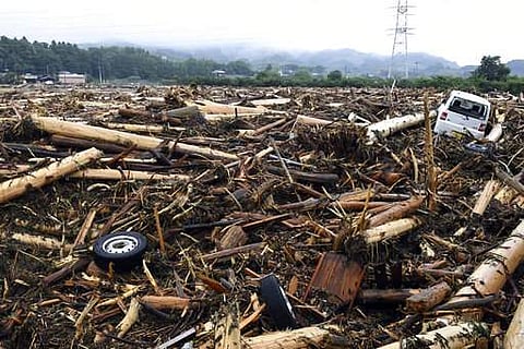 Debris caused by heavy rain are left in Asakura, Fukuoka prefecture, southwestern Japan Thursday, July 6, 2017. Heavy rain following a recent typhoon flooded many houses in southwestern Japan, forcing thousands of people to flee, authorities said. (Sadayu