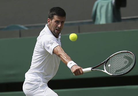 Serbia's Novak Djokovic returns the ball to Czech Republic's Adam Pavlasek during their Men's Singles Match on day four at the Wimbledon Tennis Championships in London. | AP