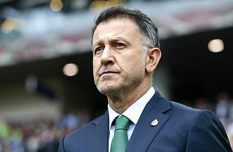 FILE - In this July 2, 2017, file photo, Mexico coach Juan Carlos Osorio waits for the kick-off of the Confederations Cup, third place soccer match between Portugal and Mexico, in Moscow, Russia. Mexico coach Juan Carlos Osorio has been effectively banned