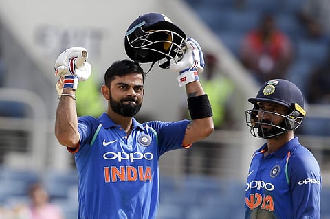 India's captain Virat Kohli celebrates after he scored a century against West Indies in his partnership with Dinesh Karthik, right, during their fifth ODI at the Sabina Park cricket ground in Kingston, Jamaica, Thursday, July 6, 2017. | AP