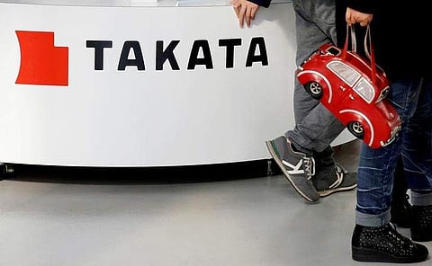Visitors walk past a logo of Takata Corp on its display at a showroom for vehicles in Tokyo, Japan. (File |Reuters)