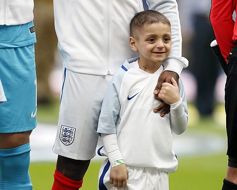 In this file photo dated Sunday, March 26, 2017, Bradley Lowery holds the hand of England's Jermain Defoe prior to the World Cup Group F qualifying soccer match between England and Lithuania at the Wembley Stadium in London, Great Britain.(AP)