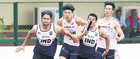 Amiya Mallick (L) competes in the 4x100m relay event on Friday. The Indian  men’s relay team was disqualified for not completing the final baton exchange inside the permitted zone  | Biswanath Swain