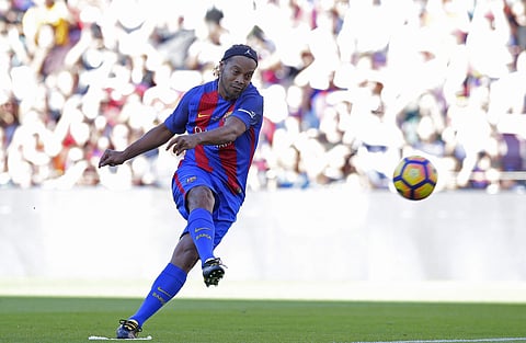 Former FC Barcelona player Ronaldinho kicks the ball during the friendly soccer match between FC Barcelona legends and Manchester United legends at the Camp Nou stadium in Barcelona, Spain, Friday, June, 30, 2017. (AP)