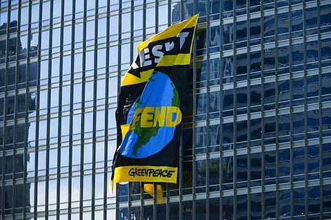 A giant banner from Greenpeace hangs on the side of Trump Tower in Chicago on Friday, July 7, 2017. Greenpeace activists unfurled the banner to protest the Trump administration's stance on global warming. (Associated Press)