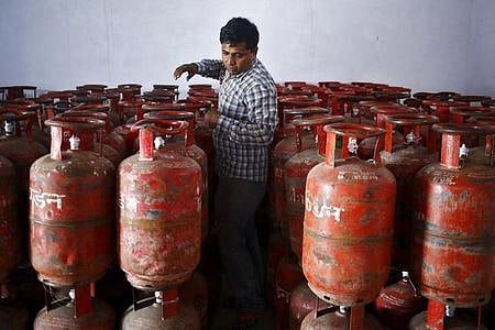 A worker arranges filled Liquefied Petroleum Gas (LPG) cylinders at a distribution centre at Dujana village in Noida, on the outskirts of New Delhi October 7, 2015. | Reuters