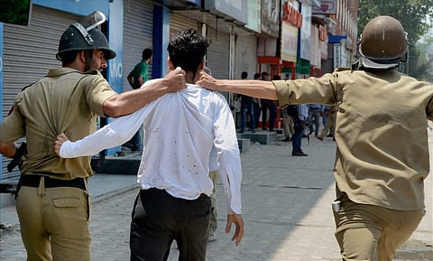 Police arrest a student during clashes which erupted following the killing of most wanted Lashkar-e-Taiba LeT Commander Abu Dhujana and his associate in Pulwama encounter in Srinagar on Tuesday. (PTI)