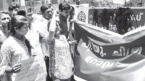 KSU activists blacken the road signage of P T Usha Road in Kochi on Monday, and cover it with a signage bearing the name of PU Chitra in protest against the ‘unfair’ treatment | Express