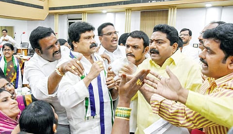 TDP and YSRC corporators engage in a heated argument during the VMC council meeting in Vijayawada on Wednesday | Express