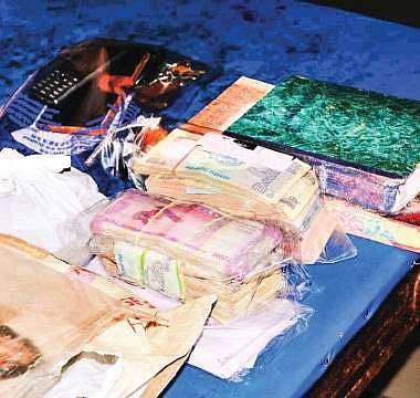 H2.2L seized from the One Town joint sub-registrar’s office during an ACB raid on Wednesday | express