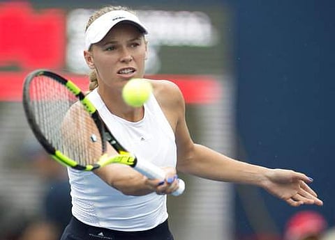 Caroline Wozniacki, of Denmark, warms up for her rain-delayed quarterfinal match against Karolina Pliskova, of the Czech Republic, at the Rogers Cup women's tennis tournament in Toronto. | AP