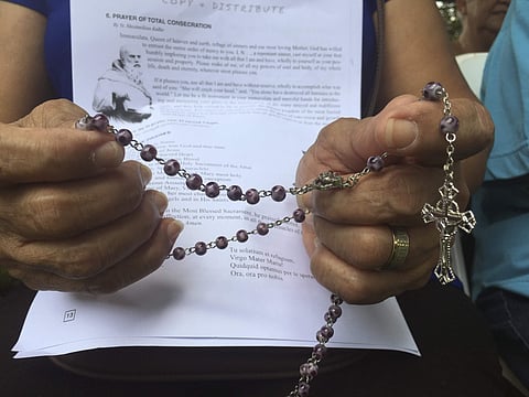 A woman holds rosary in her hand as people gather at Plaza de Espana, to pray for peace in Hagatna, Guam Sunday, Aug. 13, 2017. Residents of the U.S. Pacific island territory face a missile threat from North Korea | AP