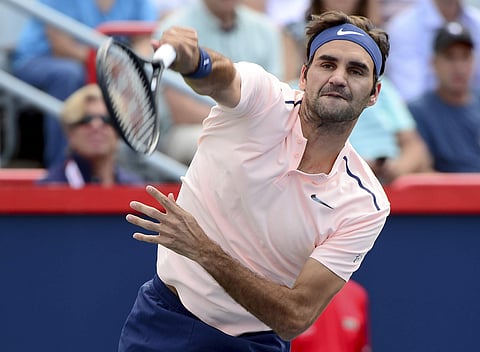 Roger Federer, of Switzerland, serves the ball to Robin Haase, of the Netherlands, during Rogers Cup tennis action, in Montreal. | AP