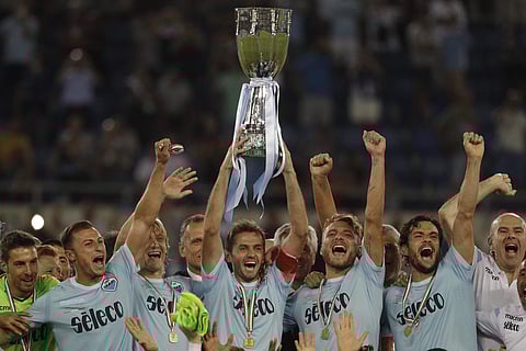 Lazio's captain Senad Lulic, center, raises the trophy at the end of the Italian Super Cup final match between Lazio and Juventus at Rome's Olympic stadium. | AP