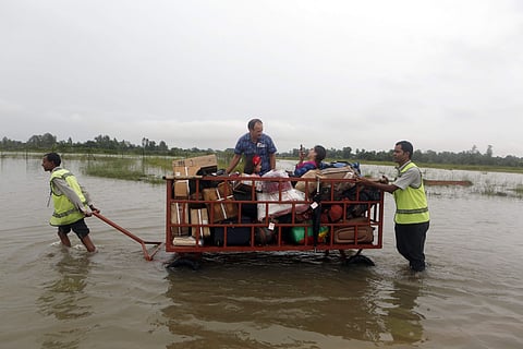 Landslides and flooding triggered by heavy rain have killed dozens of people in southern Nepal and left thousands homeless.Passengers finding their space in a luggage trolley in flooded Janakpur airport is seen in the picture. (Photo | AP)