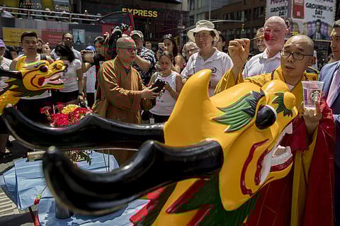 The 27th annual Hong Kong Dragon Boat Festival drew hundreds of  participants to New York.A Buddhist Monk from the World Chan Buddhist Association, performing the traditional Awakening Blessing of the Dragon Boats during the festival is seen in the pictur