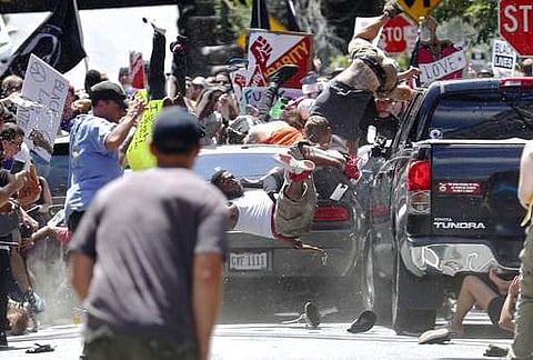 People fly into the air as a vehicle drives into a group of protesters demonstrating against a white nationalist rally in Charlottesville, Virginia on August 12. (File Photo | AP)