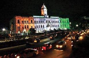 Motorists drive past the Chennai Corporation building that has been decked up in national colours on the eve of the 70th Independence Day, on Monday | p jawahar