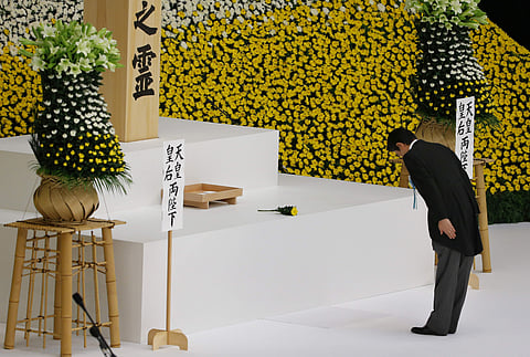 Japanese Prime Minister Shinzo Abe bows after offering prayers for the war dead in front of the main altar | AP