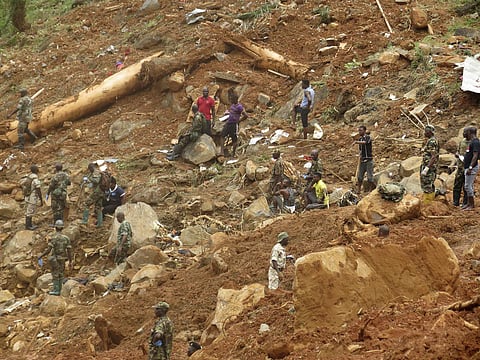 Security forces search for bodies from the scene of heavy flooding and mudslides in Regent, just outside of Sierra Leone's capital Freetown. (AP)