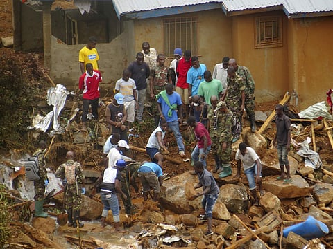 Volunteers search for bodies from the scene of heavy flooding and mudslides in Regent, just outside of Sierra Leone's capital Freetown. (AP)