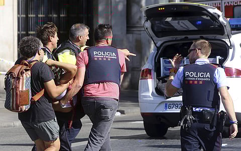 An injured person being carried in Barcelona, after a white van jumped the sidewalk in the historic Las Ramblas districtict of Barcelona. (Photo | AP)