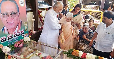 District Minister A Manju with Susheela, wife of leader B B Shivappa, at Kumbarahalli in Sakleshpur taluk on Tuesday | Express