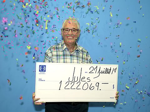 In this Thursday, July 27, 2017 photo provided by Loto-Quebec, Jules Parent poses with a mock check after winning a million Canadian dollars playing the lottery, in Quebec City. (Photo | AP)