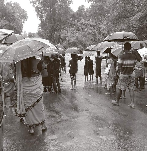 People gather at Tarlakota in MV-37 to see flood water flowing four feet over the low lying bridge in Malkangiri district on Saturday I Express