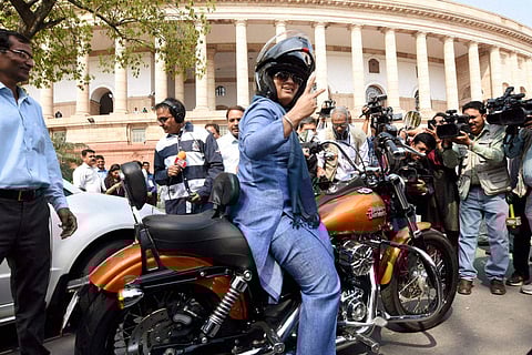 Ranjeet Ranjan, Lok Sabha MP from Supaul (Bihar), rides a Harley Davidson bike at Parliament in New Delhi on International Women's Day. (PTI Photo)