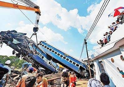 A coach of the Utkal Express train being hauled off the tracks by a crane, at the accident site in Muzaffarnagar on Sunday | PTI