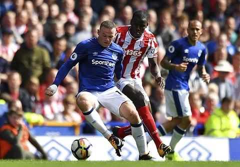 Everton's Wayne Rooney, left, in action during the English Premier League soccer match between Everton and Stoke CIty. | AP