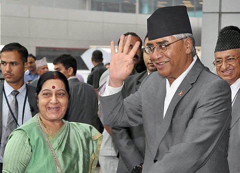 External Affairs Minister Sushma Swaraj receives Prime Minister of Nepal Sher Bahadur Deuba on his arrival at the IGI Airport in New Delhi on Wednesday. | PTI