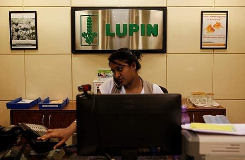 An employee of Lupin Limited works at a reception at their headquarters in Mumbai. (File Photo | Reuters)