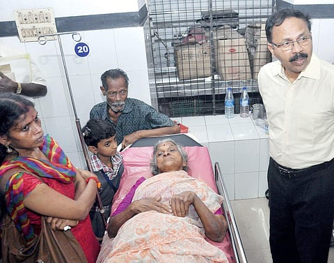 KSHRC Acting Chairperson P Mohanadas visiting the elderly couple evicted from their house at the Ernakulam General Hospital on Thursday