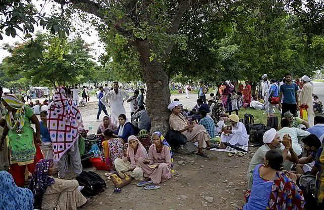 Followers of Gurmeet Ram Rahim Singh, the controversial head of religious sect Dera Sacha Sauda (DSS), gather on the roadside in Sirsa, where his organization is based, on August 24, 2017, ahead of the verdict in the rape case against them.