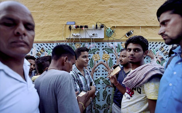 Dera Sacha Sauda followers charging their phones as they wait for the verdict. Mobile internet and data services have been suspended for 72 hours in Punjab, Haryana and Chandigarh. (Photo | PTI)