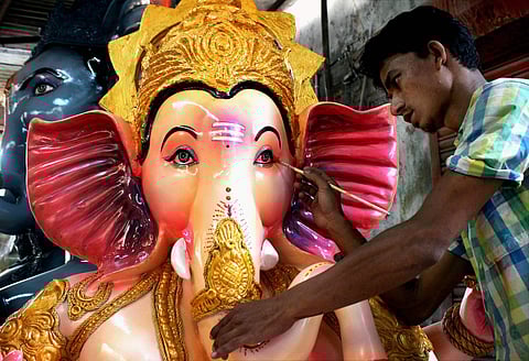 An artist gives final touches to an idol of Lord Ganesha ahead of Ganesh festival in Nagpur, Maharashtra. (PTI)