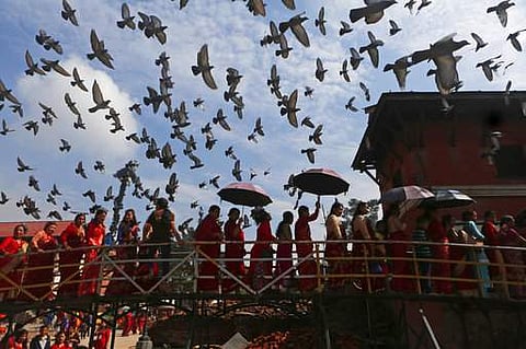 Nepalese Hindu women stand in a queue to enter Pashupatinath temple to offer prayers for their husbands during Teej festival celebrations in Kathmandu.