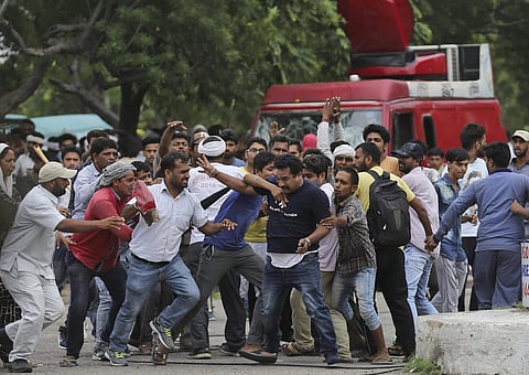 Panchkula Supporters of the Dera Sacha Sauda sect attack a member of the media in Panchkula on Friday. (Photo | PTI)