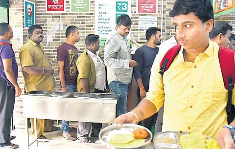 People queue up at the Appaji Canteen in Hanumanthanagar