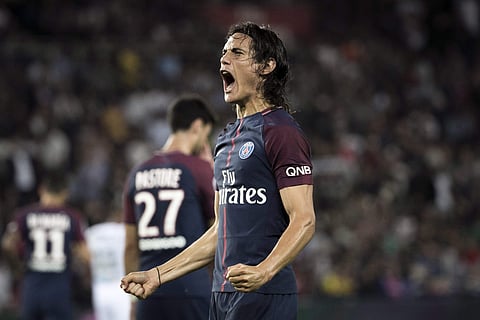 PSG's Edinson Cavani celebrates scoring a goal, during the French League One soccer match between Paris Saint Germain and Saint Etienne. | AP