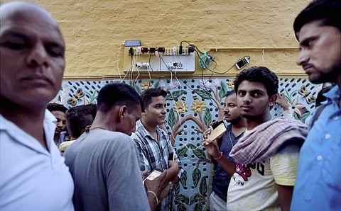 Dera Sacha Sauda followers charging their phones while they waited for the verdict. Mobile internet and data services have been suspended for 72 hours in Punjab, Haryana and Chandigarh. (Photo | PTI)