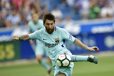 FC Barcelona's Lionel Messi, kicks the ball to score a goal during the Spanish La Liga soccer match between FC Barcelona and Deportivo Alaves, at Mendizorroza stadium, in Vitoria, northern Spain, Saturday, Aug. 26, 2017. | AP