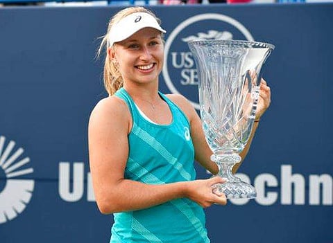 Daria Gavrilova, of Australia, holds the trophy after her 4-6, 6-3, 6-4 victory over Dominika Cibulkova, of Slovakia, in the final of the Connecticut Open tennis tournament in New Haven, Conn., Saturday, Aug. 26, 2017. | AP