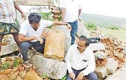 Archaeologist E Siva Nagi Reddy examining the broken pillars found at a Buddhist site on Bhairava Gutta in Guntur district on Sunday | Express
