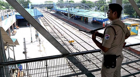 A personnel of Para-Military force stand guards deserted Rohtak train station on Sunday. | PTI