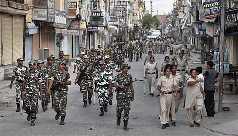 Security forces personnel and police men patrolling a street in Sirsa after the pronouncement of quantum of sentence for Gurmeet Ram Rahim in the two rape cases on Monday. | PTI