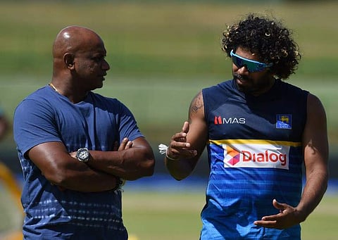 Sri Lankan cricketer Lasith Malinga (L) speaks with chairman of selectors Sanath Jayasuriya during a practice session at the Pallekele International Cricket Stadium in Pallekele.|AFP