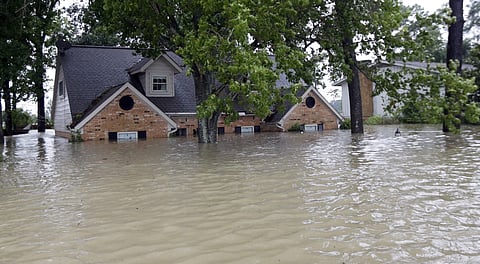 A home is surrounded by floodwaters from Tropical Storm Harvey on Monday, Aug. 28, 2017, in Spring, Texas. | AP